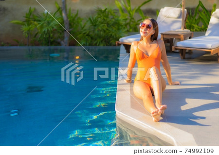 Portrait beautiful young asian woman enjoy relax around swimming pool Portrait beautiful young asian woman enjoy relax around swimming pool 74992109