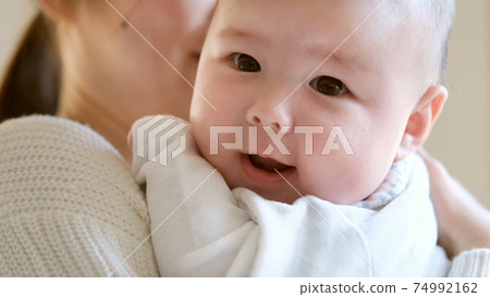 Mother hugging baby Mother hugging baby 74992162