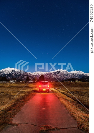 Moonlit night drive: Overlooking the Northern Alps from Omachi City 74992189