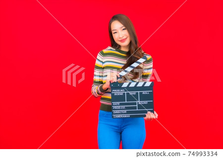 Portrait beautiful young asian woman with movie slate cutting 74993334