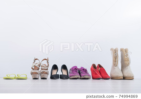 Women's footwear collection for any weather and all seasons. A row of women's shoes Women's footwear collection for any weather and all seasons. A row of women's shoes 74994869