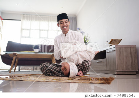 father and daughter playing after praying together father and daughter playing after praying together 74995543