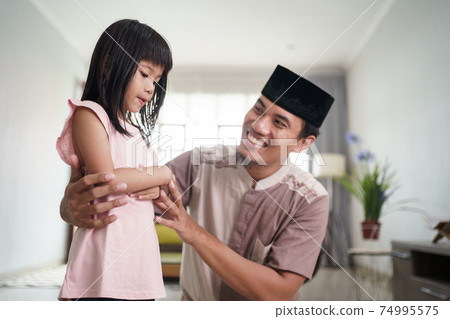 muslim father teaching her daughter how to pray at home muslim father teaching her daughter how to pray at home 74995575
