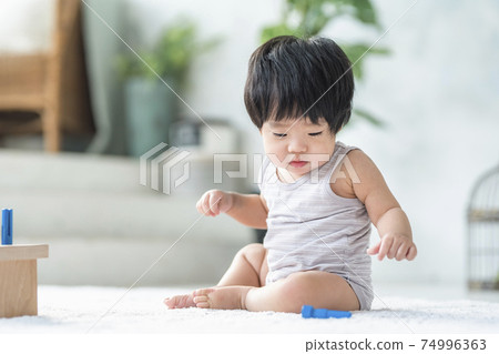 0 year old baby playing with wooden toys 0 year old baby playing with wooden toys 74996363