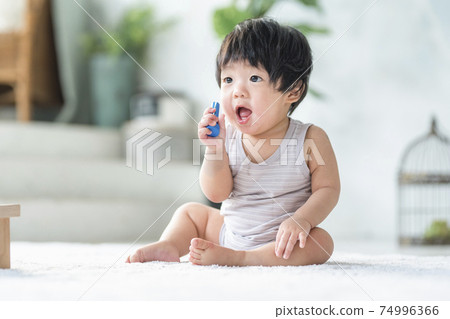 0 year old baby playing with wooden toys 0 year old baby playing with wooden toys 74996366