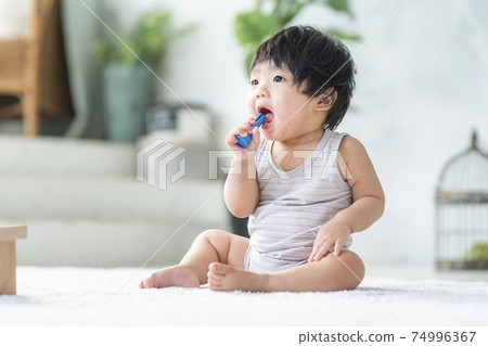 0 year old baby playing with wooden toys 0 year old baby playing with wooden toys 74996367