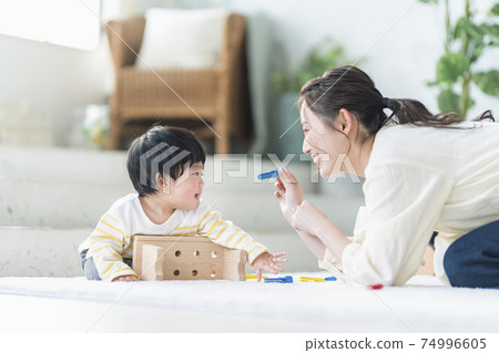 Mother and child playing with wooden toys 74996605