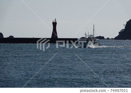 Fishing boats returning to the port 74997051