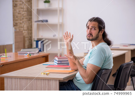 Young male student in the classroom during pandemic 74999965