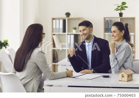 Young family happily clenching their fists at buying a house or getting mortgage approval. Young family happily clenching their fists at buying a house or getting mortgage approval. 75000403