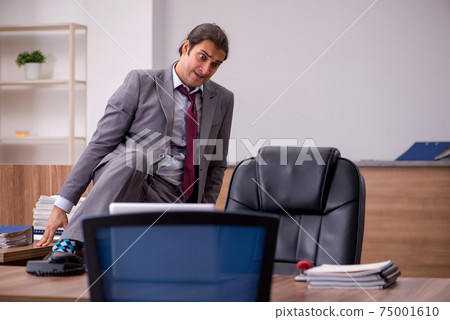 Young businessman employee in bullying concept in the office 75001610