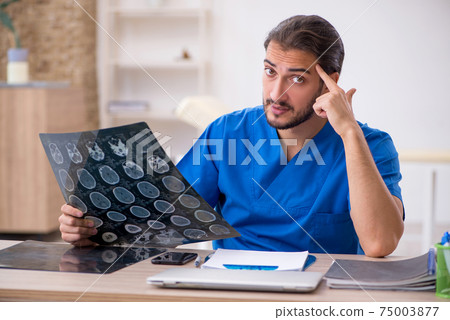 Young male doctor radiologist working in the clinic Young male doctor radiologist working in the clinic 75003877