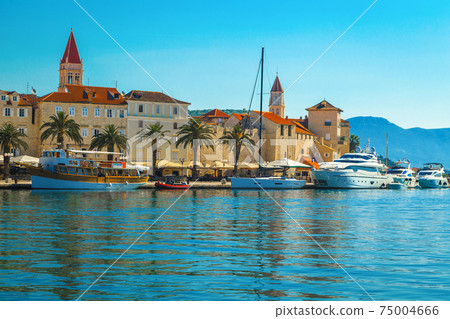 Anchored boats and waterfront promenade with palms in Trogir, Croatia 75004666