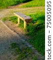 Old wooden bench made from a tree trunk in a park 75005095