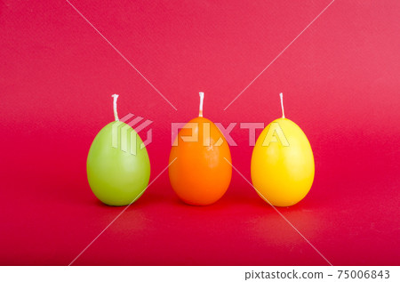Bright colored decorative candles in shape of eggs. Bright colored decorative candles in shape of eggs. 75006843