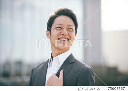 A man in a Japanese businessman suit with a smile in his thirties 75007567