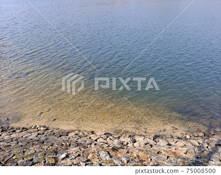 Undulating river and piled stones 75008500