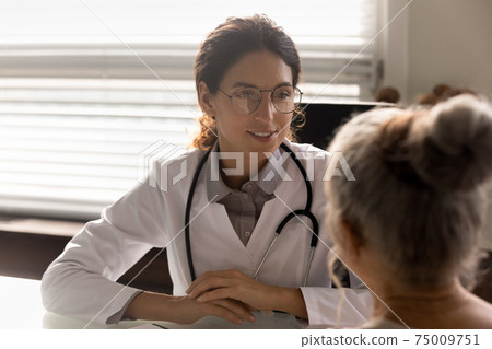 Close up smiling female doctor wearing glasses consulting mature patient Close up smiling female doctor wearing glasses consulting mature patient 75009751