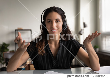 head shot portrait smiling woman wearing headphones consulting client online head shot portrait smiling woman wearing headphones consulting client online 75009842