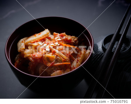 Korean food, Cabbage kimchi in black dish set on dark background. Korean food, Cabbage kimchi in black dish set on dark background. 75010791