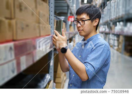 Portrait Asian men, staff, product counting Warehouse Control Manager Standing, counting and inspecting products in the warehouse Portrait Asian men, staff, product counting Warehouse Control Manager Standing, counting and inspecting products in the warehouse 75010946