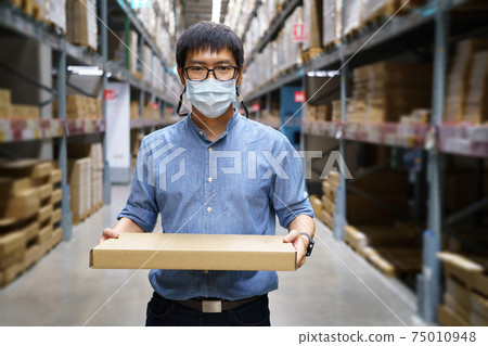 Portrait Asian men, staff, product counting Warehouse Control Manager Standing, counting and inspecting products in the warehouse 75010948