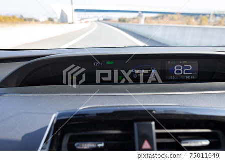 Driver's seat of a passenger car driving on a highway 75011649