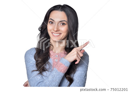 Close-up portrait of a beautiful woman pointing 75012201