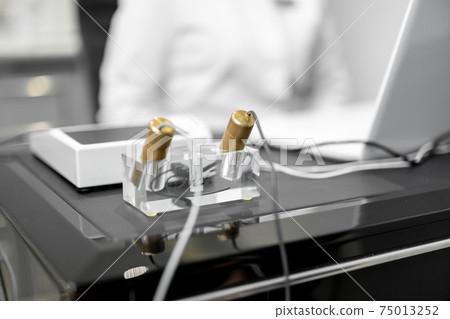 Bioenergetic testing device with brass handpieces in medical clinic 75013252