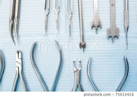Dental tools for orthodontic treatment lying on the table 75013428