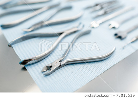 Dental tools for orthodontic treatment lying on the table 75013539