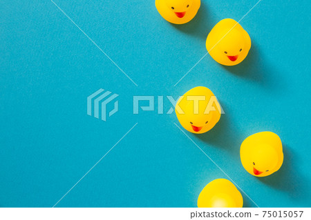 Yellow rubber duck doll on mint blue background 75015057