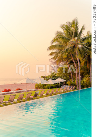 Umbrella and chair around swimming pool with sea ocean view 75018499