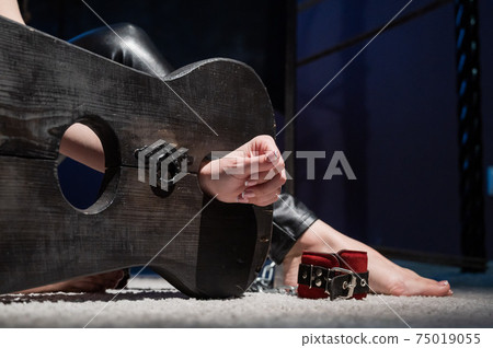 Female hands in wooden shackles during  Stock Photo 75019055  