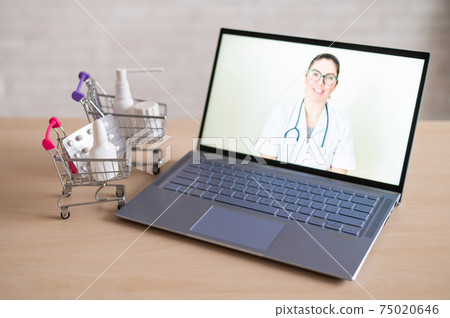 Online medicine. Remote reception at the female doctor. A computer application for the purchase of medicines in a pharmacy with home delivery. Pharmacist recommending medication on laptop screen. 75020646