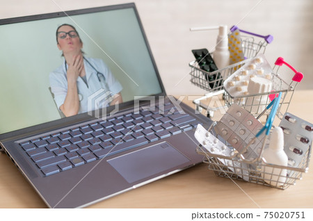 Online medicine and pharmacy concept. A female doctor conducts an online consultation and recommends medications. Mini trolley with tablets at the laptop. Online medicine and pharmacy concept. A female doctor conducts an online consultation and recommends medications. Mini trolley with tablets at the laptop. 75020751