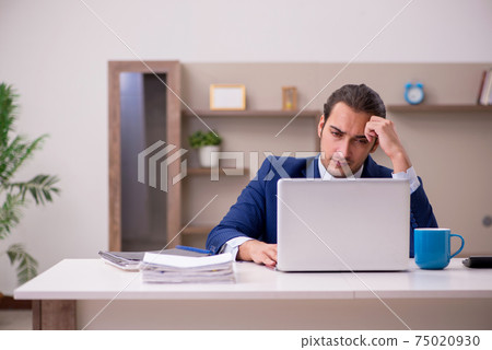 Young male employee working from home in pandemic concept Young male employee working from home in pandemic concept 75020930