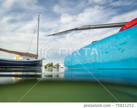 Stand up paddleboard and sailboat 75021252