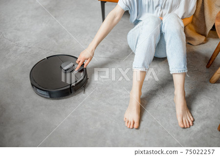 Robotic vacuum cleaner cleaning the room at home Robotic vacuum cleaner cleaning the room at home 75022257