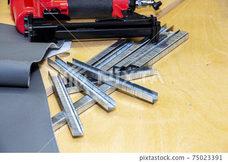 concept of furniture production and repair. Stapler and staples, working tool 75023391