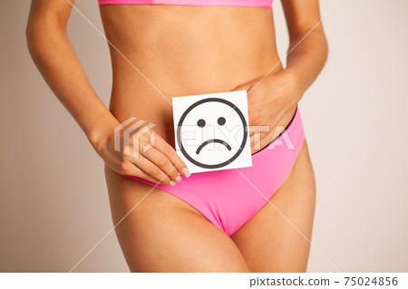 Woman Health, Female Body Holding Sad Smile Card Near Stomach. Woman Health, Female Body Holding Sad Smile Card Near Stomach. 75024856