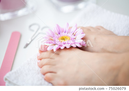 Cheerful Girl Doing Nails Making Pedicure Sitting In Bed Indoor. 75026079