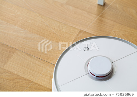 Smart House, vacuum cleaner robot runs on wood floor in a living room Smart House, vacuum cleaner robot runs on wood floor in a living room 75026969
