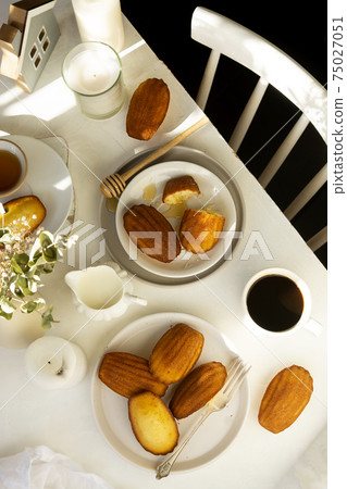 Table top of breakfast table and chair. Madeleine cakes, french pastry. 75027051