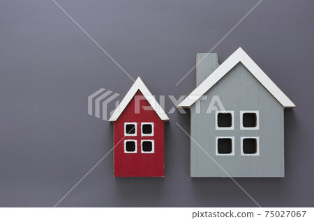 Wooden models of houses. Rent, buying or mortgage concept. Gray background. Copy space. Wooden models of houses. Rent, buying or mortgage concept. Gray background. Copy space. 75027067