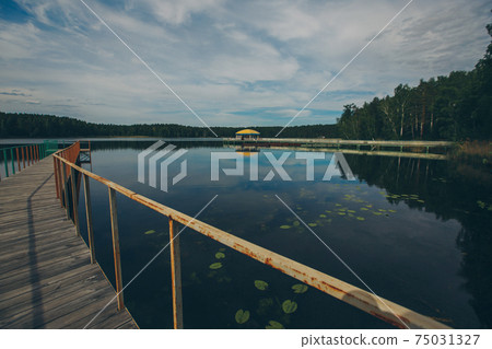 fishing bridge by the river. docks for boats on the lake. water and transport 75031327