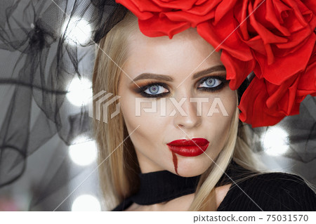 Vampire woman smirking and looking at camera Vampire woman smirking and looking at camera 75031570