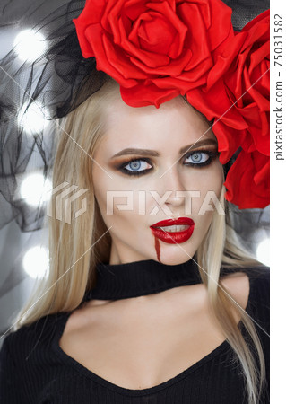 Gorgeous vampire female looking at camera 75031582