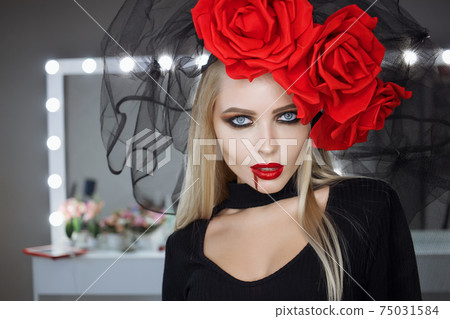 Vampire woman smirking and looking at camera 75031584