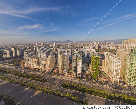 Beautiful My Khe beach from drone in Da Nang, Vietnam, street and buildings near the Central beach and the sea. Photo from a drone Beautiful My Khe beach from drone in Da Nang, Vietnam, street and buildings near the Central beach and the sea. Photo from a drone 75031964